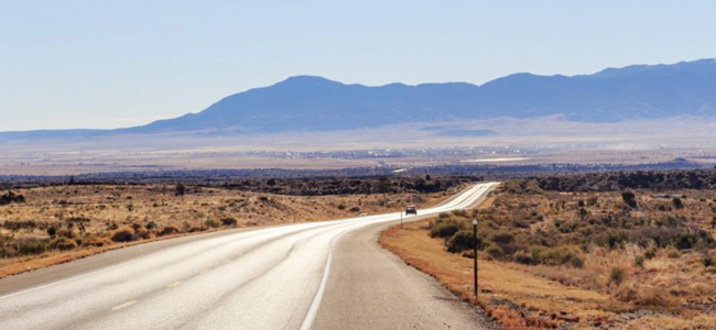 desert highway with mountains in the distance